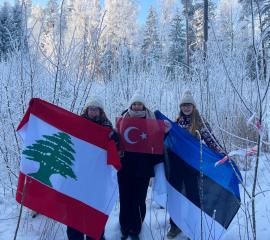 Picture of SEPers from Türkyie and Lebanon in Estonian winter nature with flags.